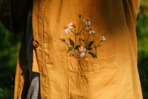 Close-up of a yellow jacket featuring delicate floral embroidery on a sunny day in Vietnam.