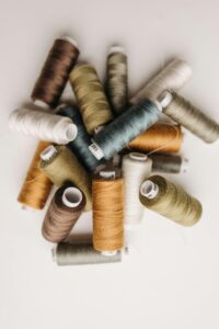 A vibrant collection of sewing threads in an artistic flat lay arrangement.
